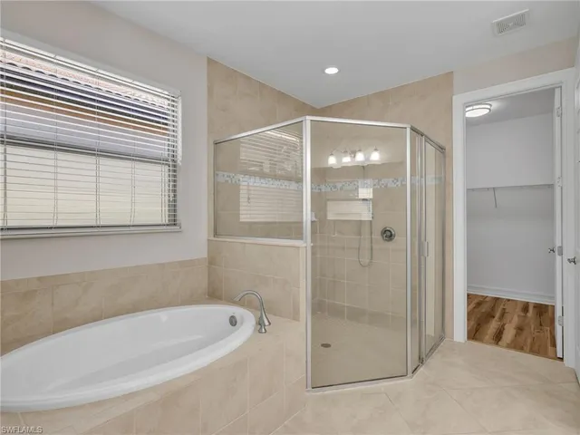 a bathroom with a tub and a shower