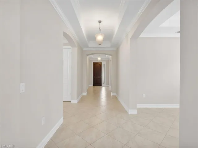 a view of a hallway with wooden floor and a large window