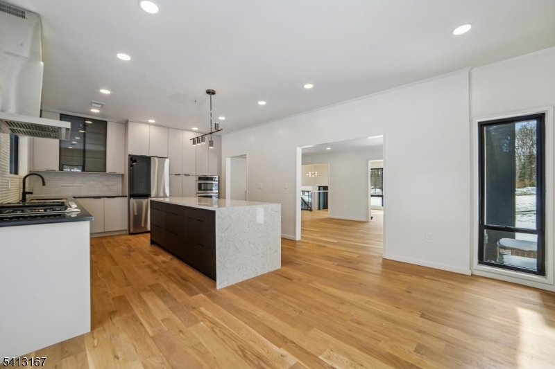 156 Park Road Parsippany, NJ 07054 - Photo 10 of 44 a large kitchen with stainless steel appliances kitchen island a large counter top and a wooden floors