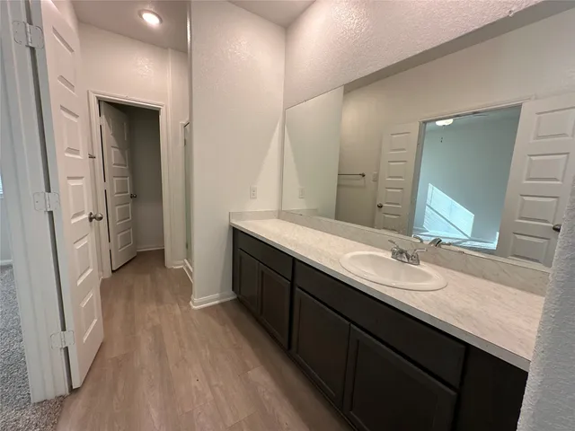 a spacious bathroom with a double vanity sink and a mirror