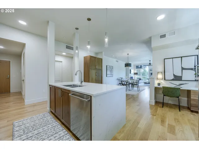 a open kitchen with stainless steel appliances kitchen island granite countertop a refrigerator and a stove top oven