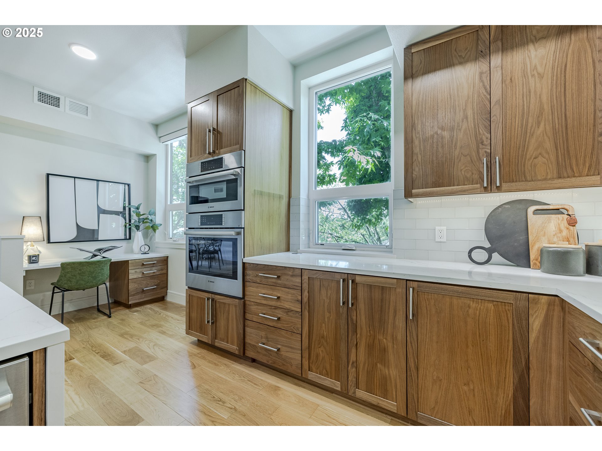 1600 Pearl Street, Unit 303 Eugene, OR 97401 - Photo 13 of 32 a kitchen with stainless steel appliances wooden cabinets a stove and a refrigerator