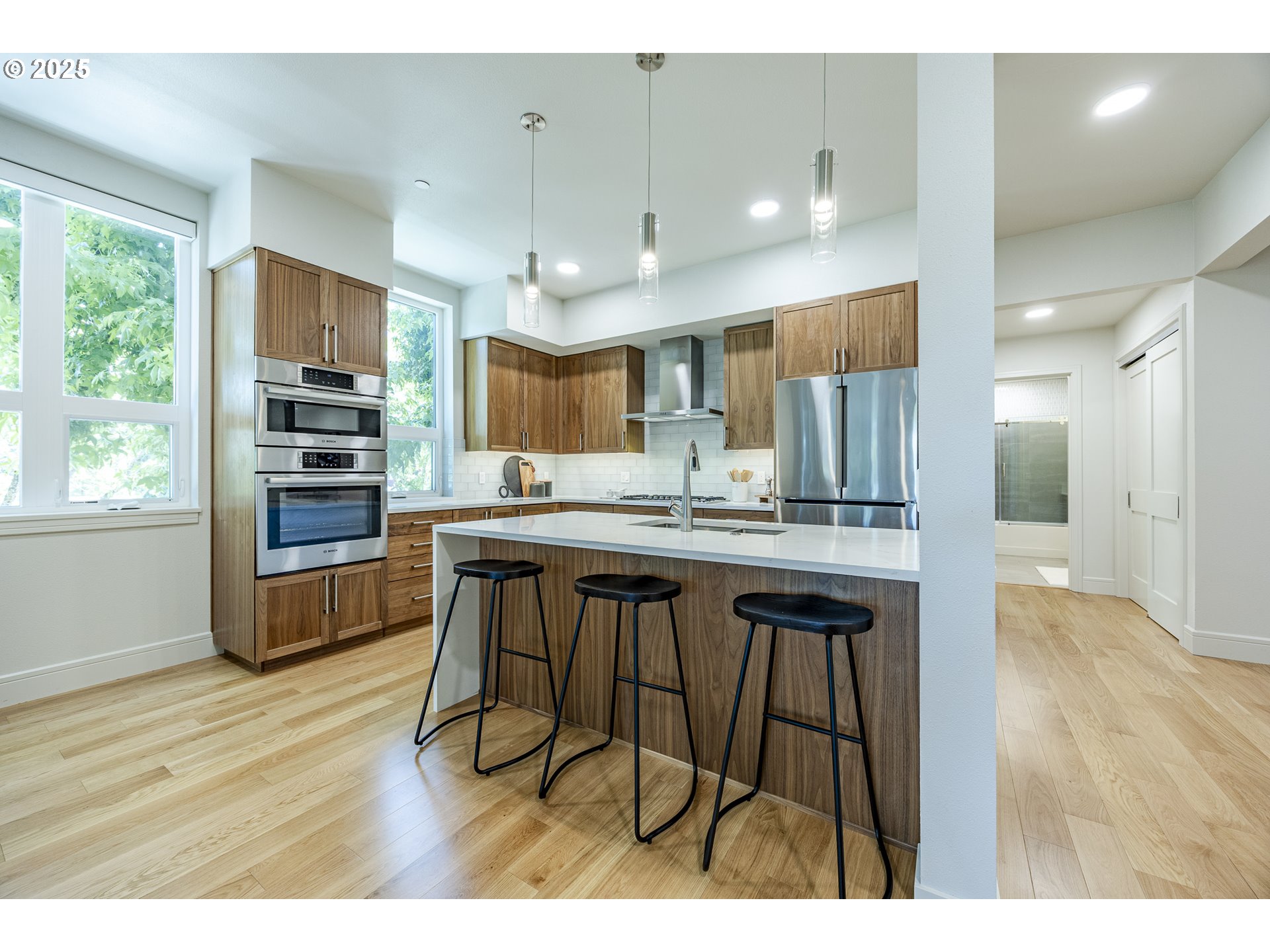 1600 Pearl Street, Unit 303 Eugene, OR 97401 - Photo 14 of 32 a open kitchen with stainless steel appliances kitchen island granite countertop a refrigerator and a stove top oven