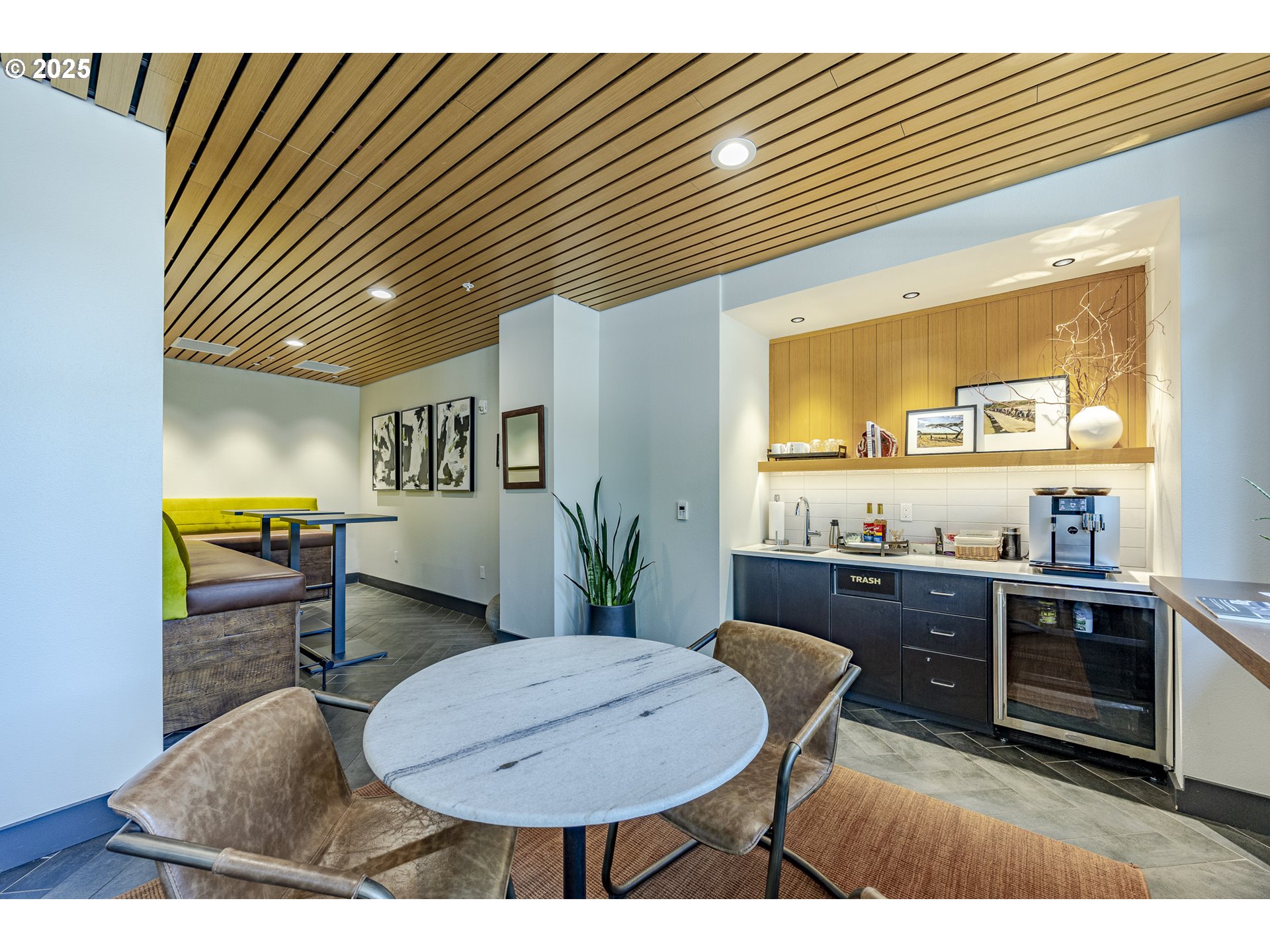 1600 Pearl Street, Unit 303 Eugene, OR 97401 - Photo 30 of 32 a kitchen with stainless steel appliances granite countertop a sink a stove a kitchen island with chairs and wooden floor