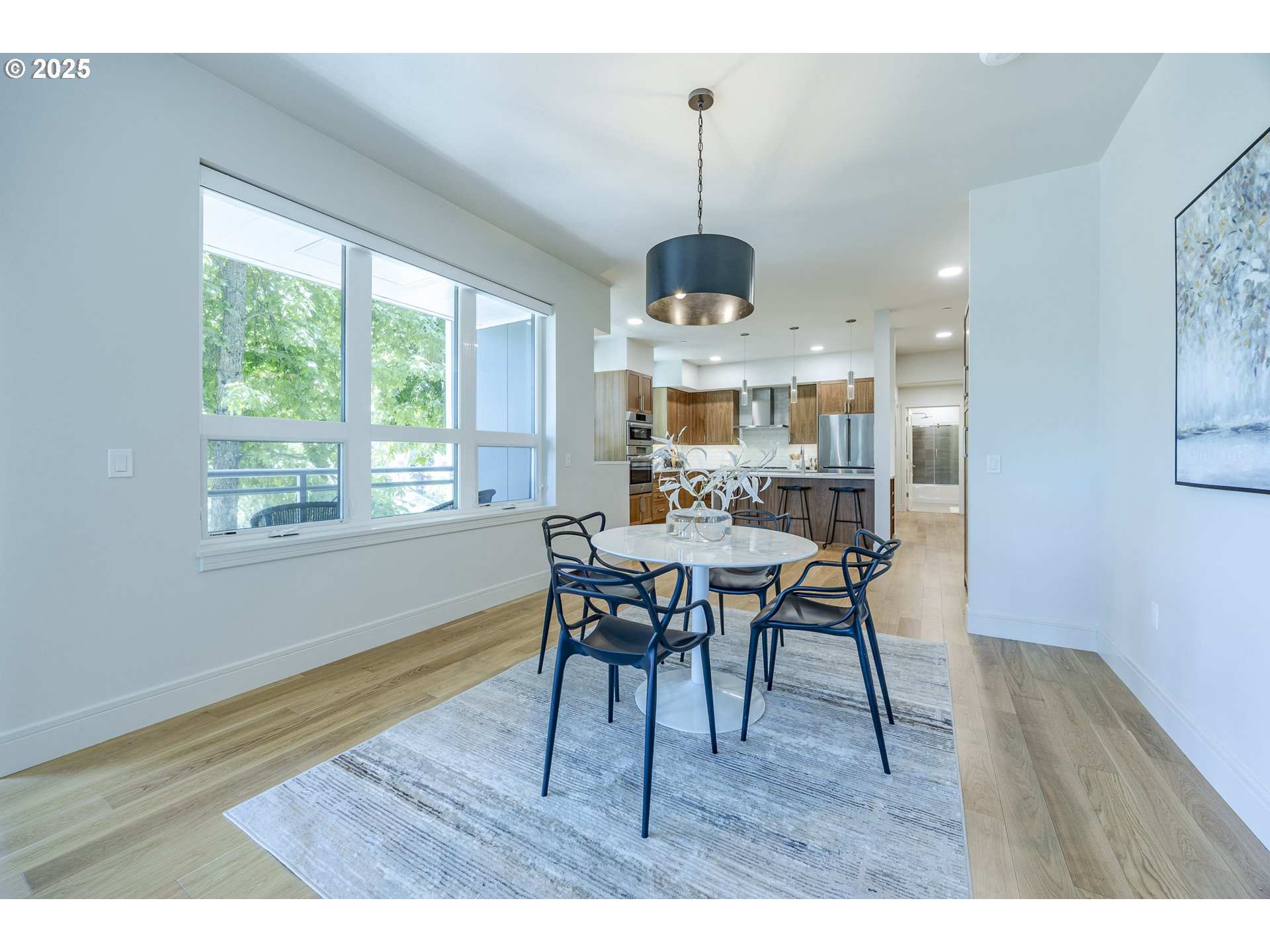 1600 Pearl Street, Unit 303 Eugene, OR 97401 - Photo 9 of 32 a view of a dining room with furniture window and wooden floor