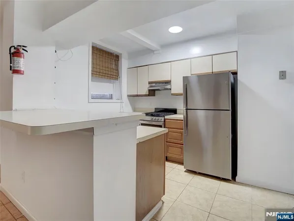 a kitchen with stainless steel appliances a refrigerator and a stove