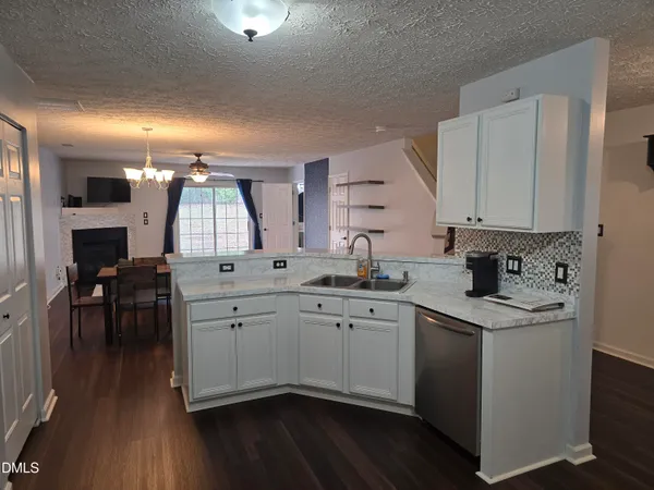 a view of a dining room with a table and chairs
