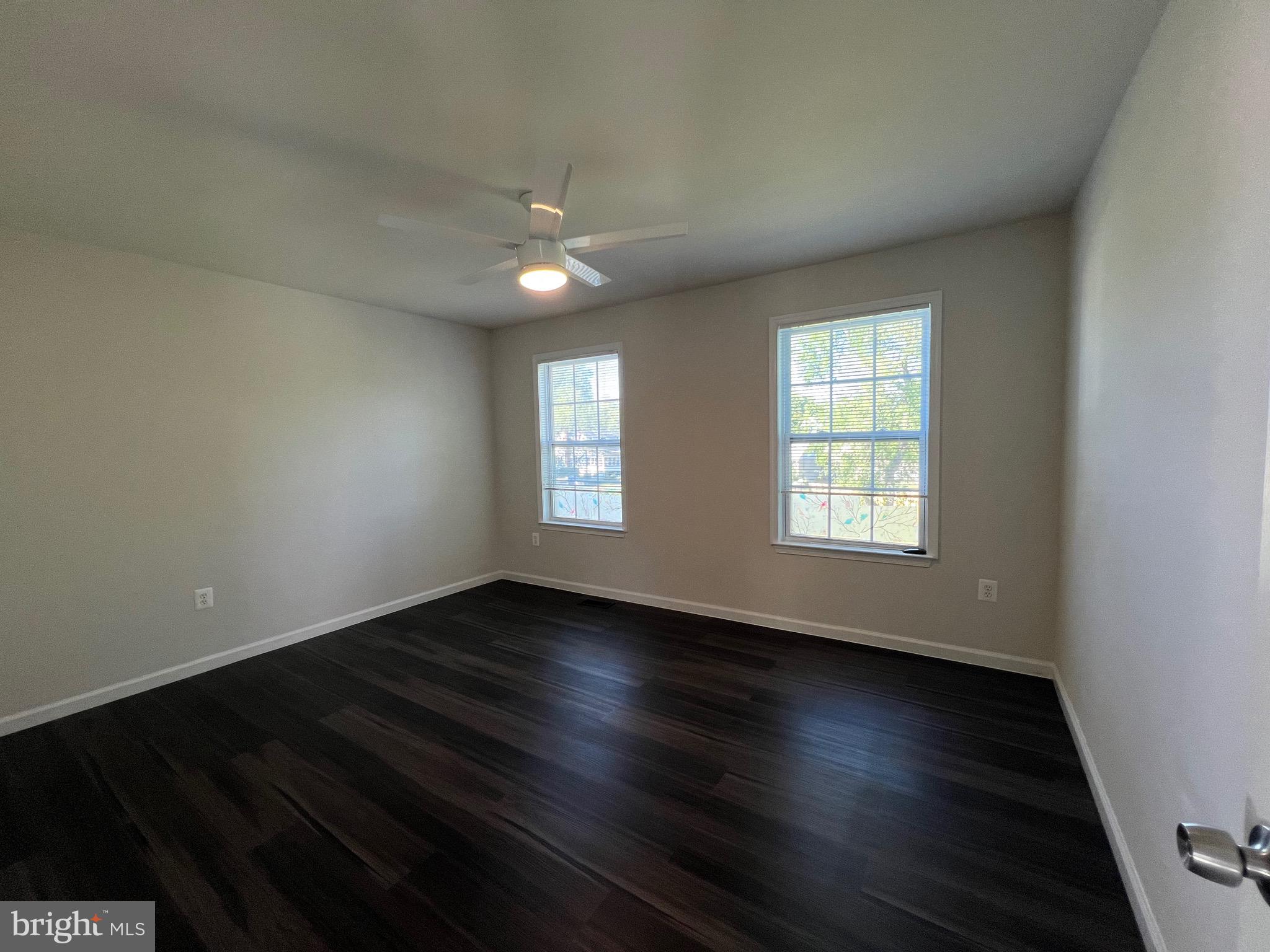 6604 Suitland Road Suitland, MD 20746 - Photo 27 of 27 an empty room with wooden floor and windows