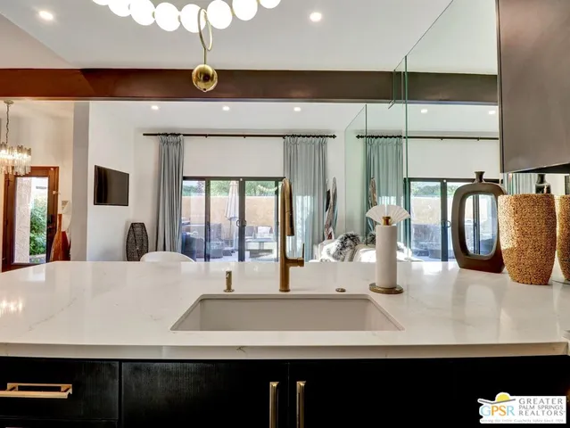 a kitchen with a sink and a refrigerator