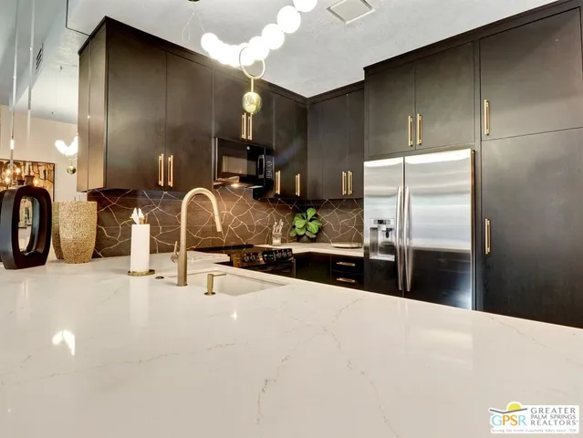 a kitchen with refrigerator and window