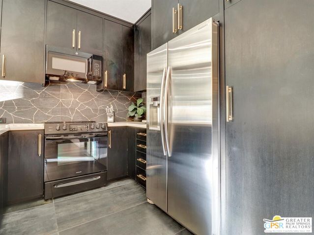 a kitchen with a refrigerator and a stove
