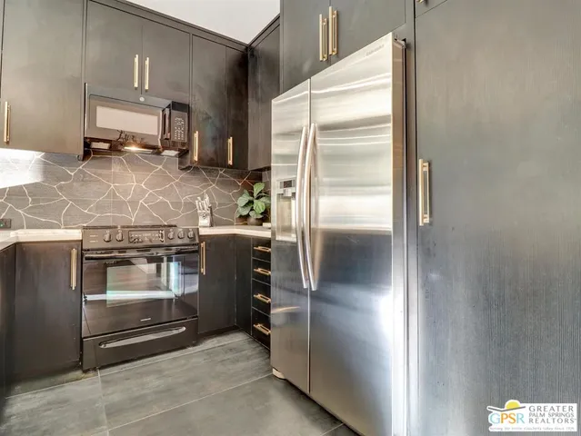 a kitchen with a refrigerator and a stove