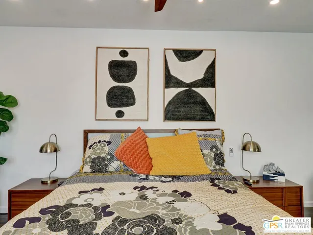 a bedroom with a bed and wall painting on the wall