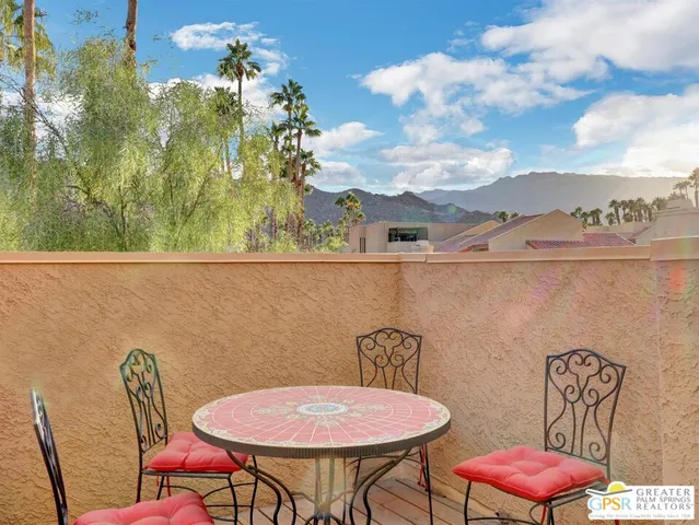 a view of a room with furniture and wooden floor