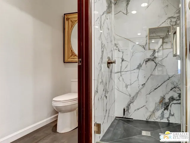 a bathroom with a toilet and a shower