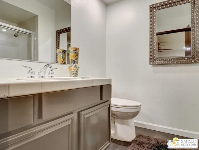 a bathroom with a sink toilet and mirror