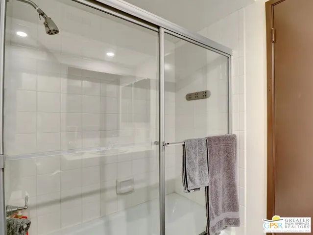 a bathroom with a glass shower door