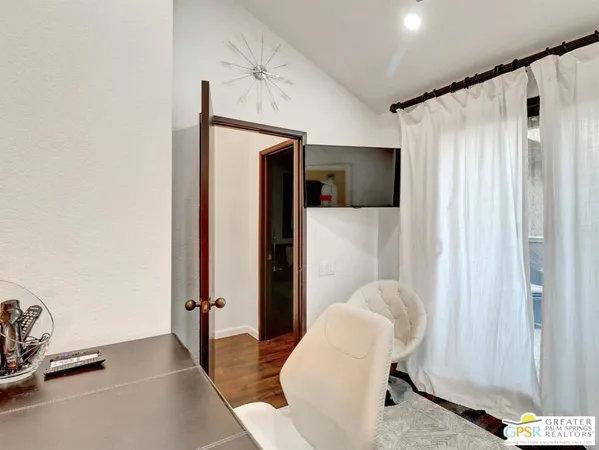 a bedroom with a bed and a chair