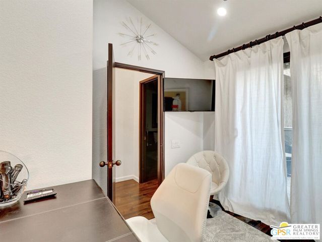 a bedroom with a bed and a chair