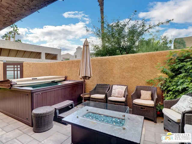 a roof deck with couches and wooden floor