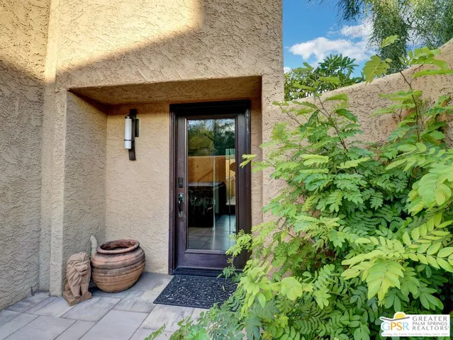 a front view of a house with chairs