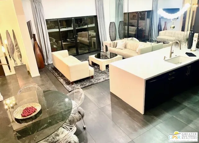 a living room with furniture and a mirror