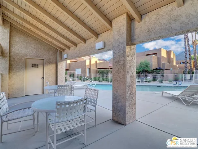 a dining room with furniture and a floor to ceiling window