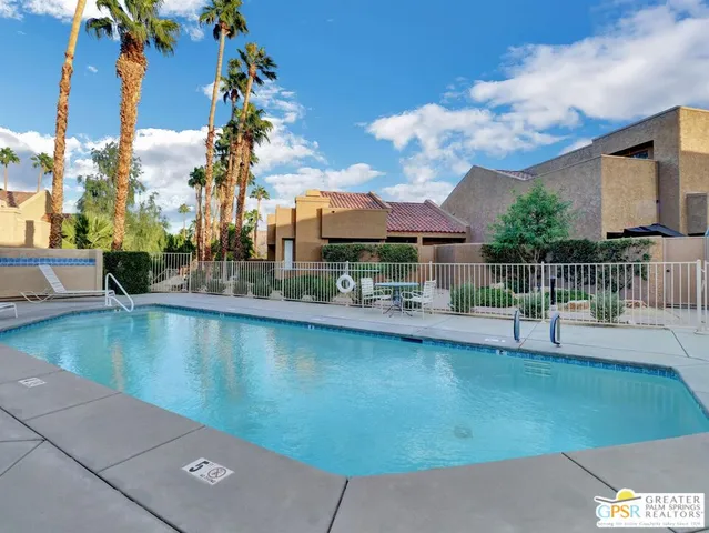 a view of a swimming pool with sitting area