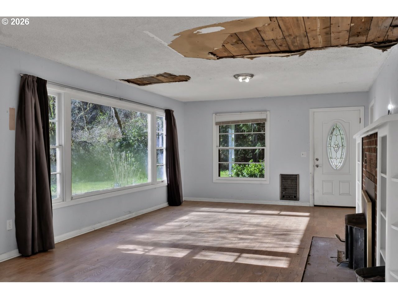 90136 Green Creek Road Swisshome, OR 97480 - Photo 11 of 42 a view of an empty room with wooden floor and a window