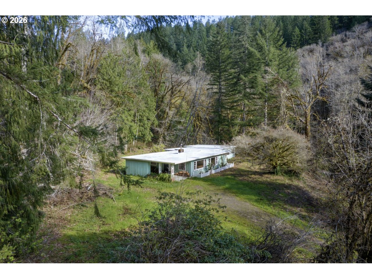 90136 Green Creek Road Swisshome, OR 97480 - Photo 7 of 42 a backyard of a house with a yard and outdoor seating