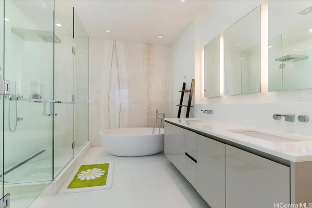 a bathroom with a granite countertop sink a toilet a mirror and shower