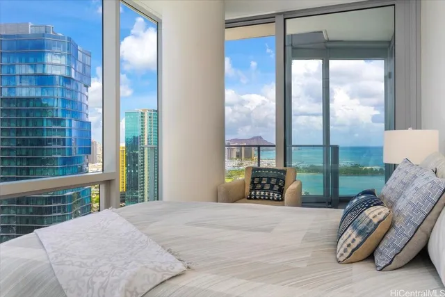 a bedroom with a large bed and a large window