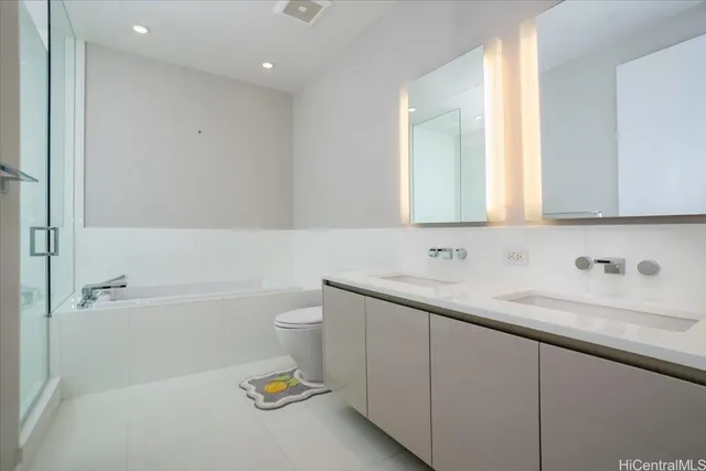 a bathroom with a granite countertop sink a toilet and bathtub
