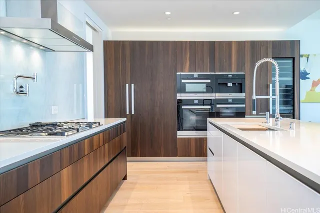a kitchen with stainless steel appliances granite countertop a stove and a refrigerator
