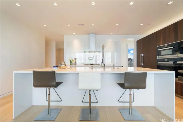 a kitchen with a dining table chairs and a counter top space