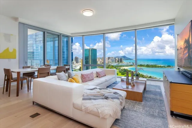 a living room with furniture and floor to ceiling windows