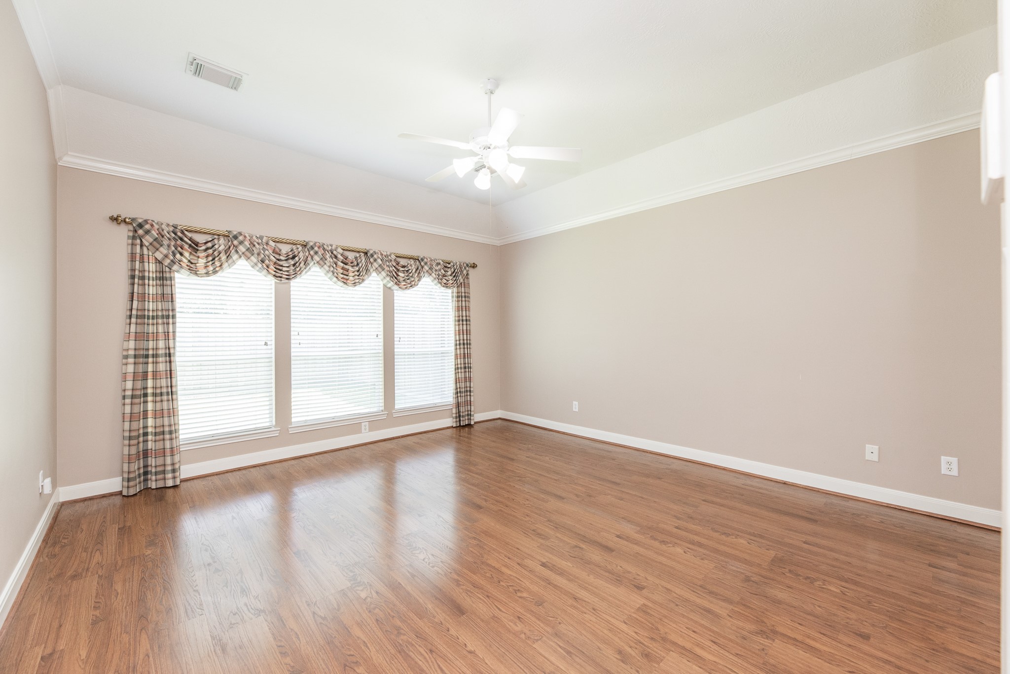 1222 Brinson Court Spring, TX 77379 - Photo 21 of 35 an empty room with wooden floor and windows