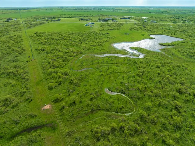 a view of a field with an ocean view