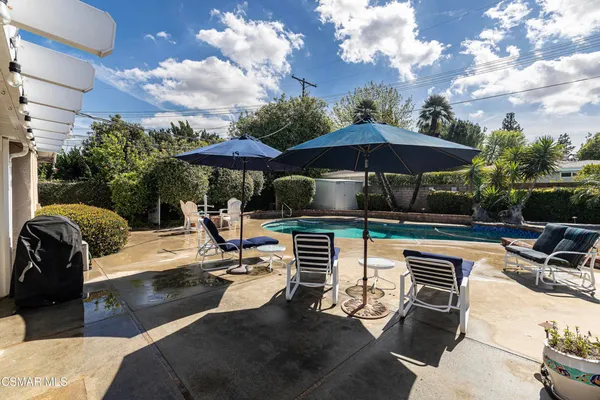 a patio with a patio table and chairs