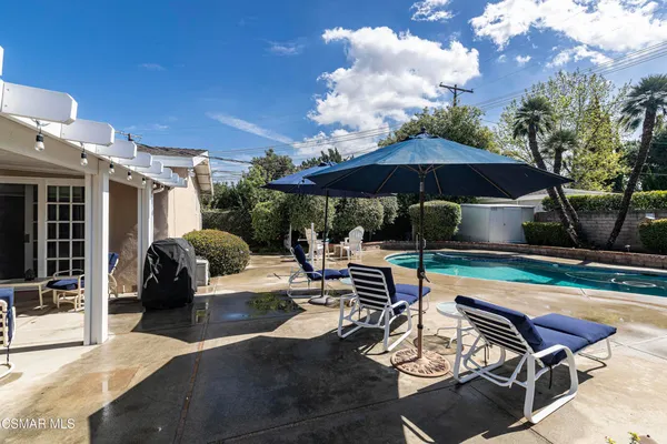 a view of a swimming pool with outdoor seating