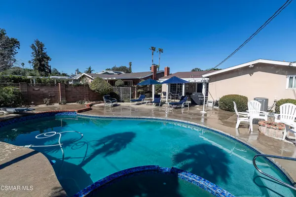 a view of a house with swimming pool and sitting area