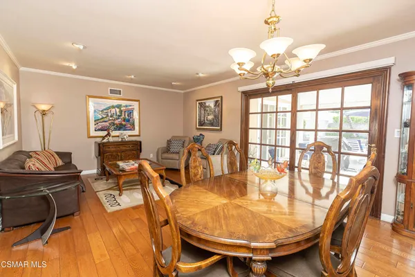 a living room with furniture a flat screen tv and a window