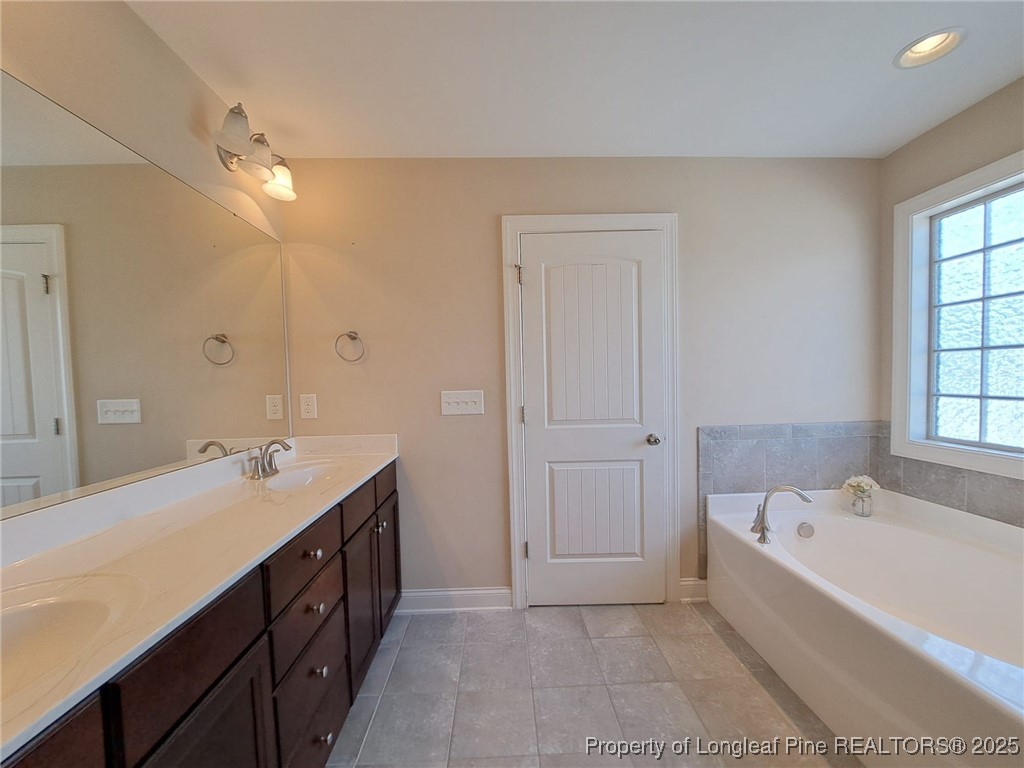 30 Appomattox Drive Cameron, NC 28326 - Photo 12 of 22 a spacious bathroom with a tub sink and mirror
