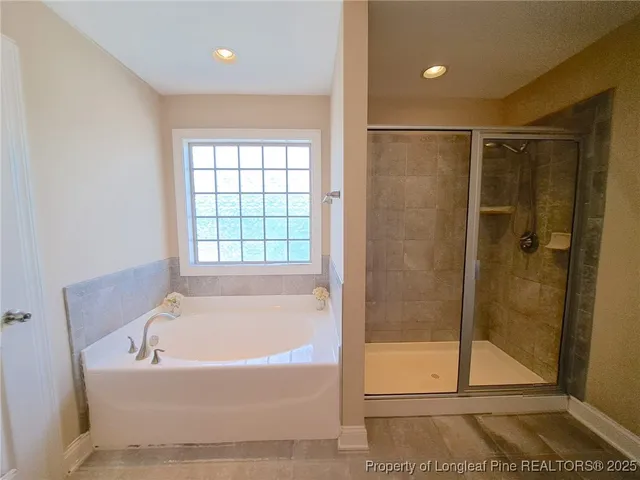 a bathroom with a bathtub and a shower