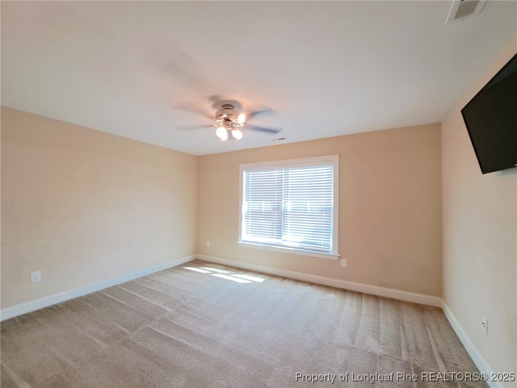 30 Appomattox Drive Cameron, NC 28326 - Photo 16 of 22 an empty room with chandelier fan and windows