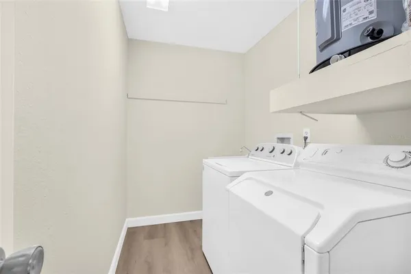 a bathroom with a granite countertop bathtub sink vanity mirror and toilet