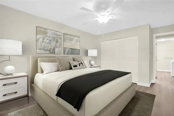 a living room with furniture and a ceiling fan