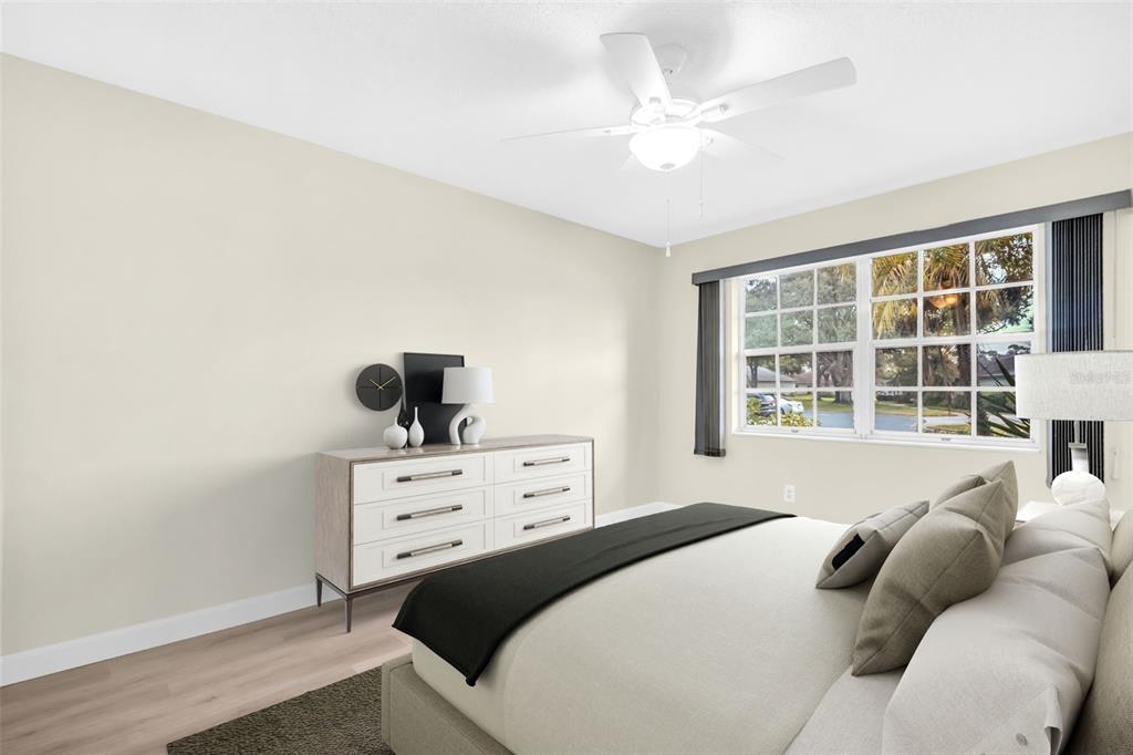 899 Cleland Court, Unit A Palm Harbor, FL 34684 - Photo 14 of 51 a bedroom with a bed a window and a dresser