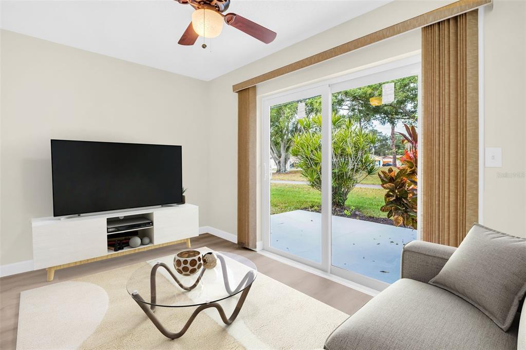 899 Cleland Court, Unit A Palm Harbor, FL 34684 - Photo 19 of 51 a living room with furniture and a flat screen tv