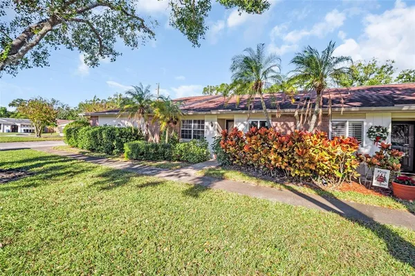 a front view of a house with a garden and a yard